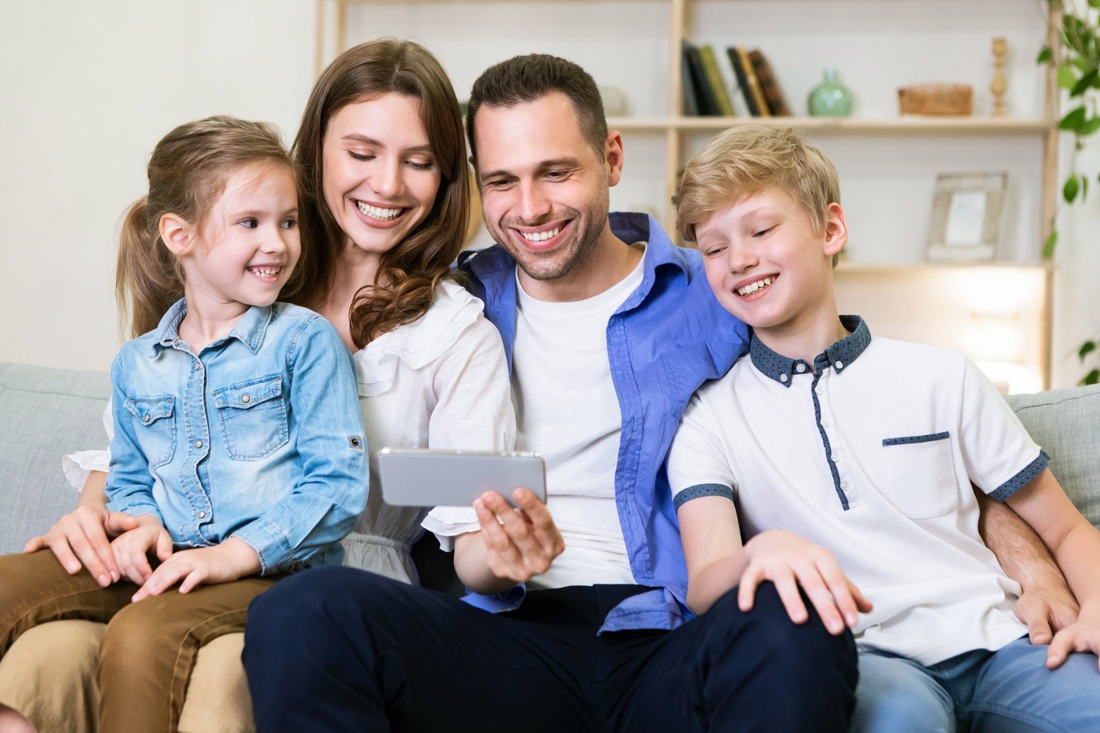 family-time-happy-dad-and-son-using-digital-tablet-browsing-internet-online-at-home-sitting-e1632233068896.jpg